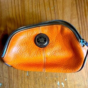 Dooney and Burke orange leather makeup bag